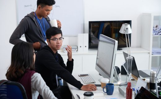 Team of Vietnamese junior programmers discussing project